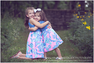 Two sisters in a natural outdoor setting during a photo session