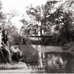 A photograph of older siblings: two brothers and their little sister overlooking a water way in the Chicago area.