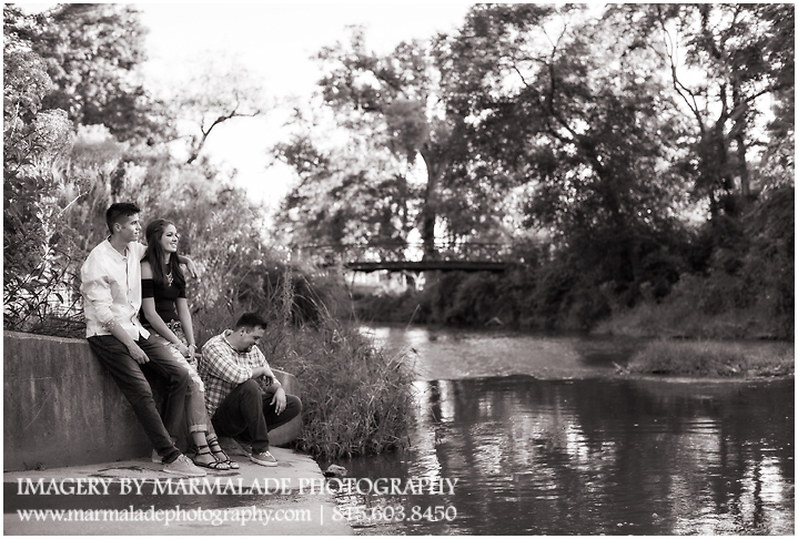 A photograph of older siblings: two brothers and their little sister overlooking a water way in the Chicago area.