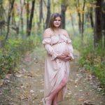 Mom to be in a wooded setting