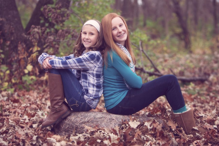 Photo of two sisters taken in the fall in the woods