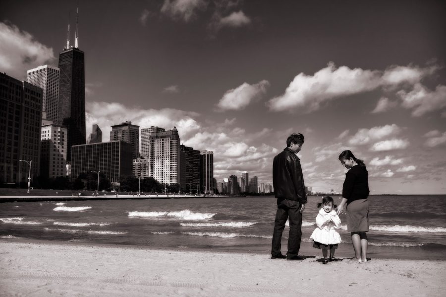 Photo of a family at Lake Michigan with Chicago's skyline in the background 
