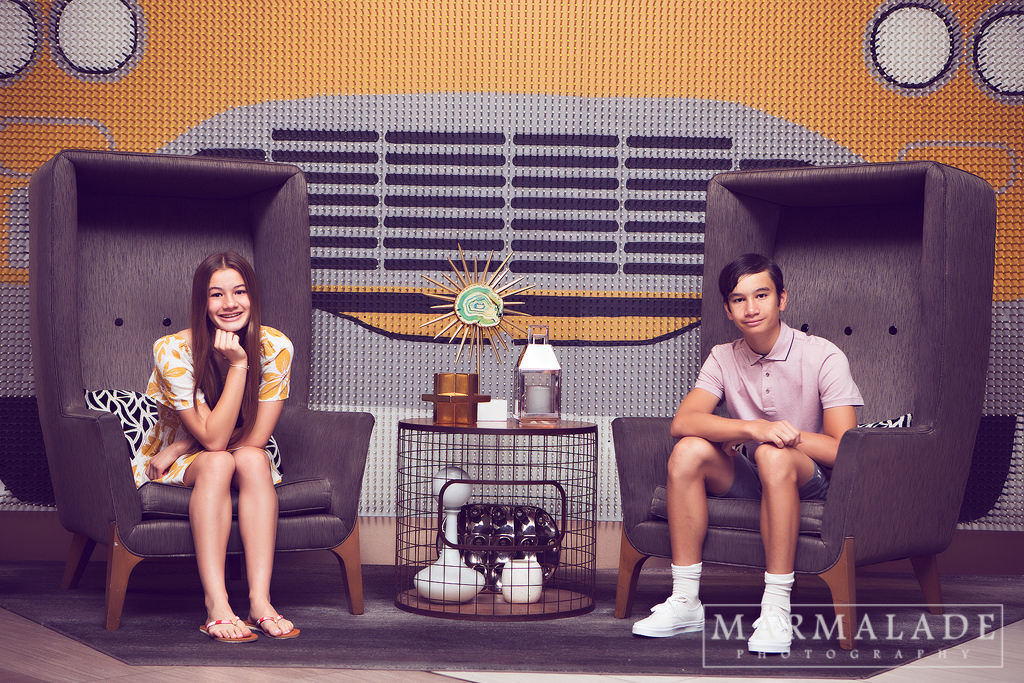 photo of two teens in front of an art installation piece